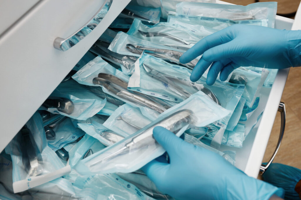Medical laboratory technician holding a set of sterile disposable instruments / Medical HS